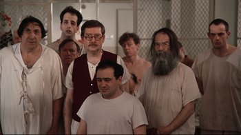 Movie still from “One Flew Over the Cuckoo's Nest” (1975), directed by Milos Forman – A group of men standing next to each other in a room; Wide shot, High angle
