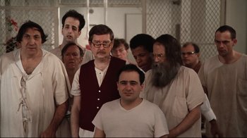 Movie still from “One Flew Over the Cuckoo's Nest” (1975), directed by Milos Forman – A group of men standing next to each other in a room; Wide shot, High angle