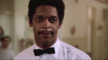 Movie still from “One Flew Over the Cuckoo's Nest” (1975), directed by Milos Forman – A person wearing a shirt and a bow tie; Close Up shot, Low angle