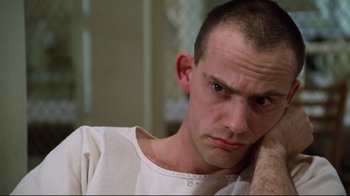 Movie still from “One Flew Over the Cuckoo's Nest” (1975), directed by Milos Forman – A person with his hand on his face; Close Up shot, Low angle