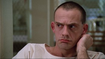 Movie still from “One Flew Over the Cuckoo's Nest” (1975), directed by Milos Forman – A person with his hand under his chin; Close Up shot, Low angle