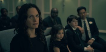 Movie still from “The Haunting of Hill House” (2018), directed by Mike Flanagan – A group of people sitting in a room; Close Up shot, Over the shoulder angle