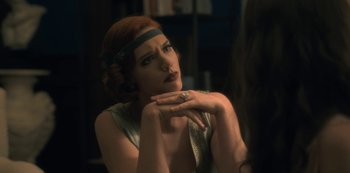 Movie still from “The Haunting of Hill House” (2018), directed by Mike Flanagan – A beautiful woman with red hair wearing a headband; Close Up shot, Over the shoulder angle