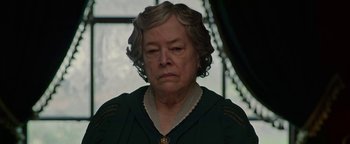 Movie still from “The Highwaymen” (2019), directed by John Lee Hancock – An older woman is looking at the camera; Close Up shot, Over the shoulder angle