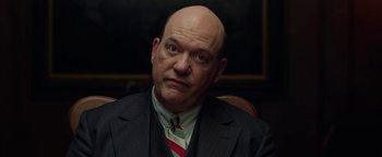 Movie still from “The Highwaymen” (2019), directed by John Lee Hancock – A man in a suit and tie sitting in front of a mirror; Close Up shot, Low angle