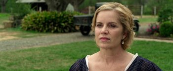 Movie still from “The Highwaymen” (2019), directed by John Lee Hancock – A person outside near grass and trees; Close Up shot, Over the shoulder angle