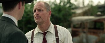 Movie still from “The Highwaymen” (2019), directed by John Lee Hancock – An older man wearing suspenders and a tie; Close Up shot, Over the shoulder angle