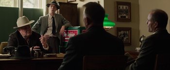 Movie still from “The Highwaymen” (2019), directed by John Lee Hancock – A man sitting in front of another man in front of a mirror; Medium shot, Over the shoulder angle