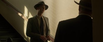 Movie still from “The Highwaymen” (2019), directed by John Lee Hancock – A man in a suit and a hat standing in front of a mirror; Medium shot, Over the shoulder angle