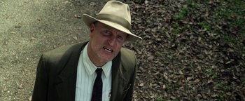 Movie still from “The Highwaymen” (2019), directed by John Lee Hancock – An older man wearing a suit and a hat; Close Up shot, Low angle