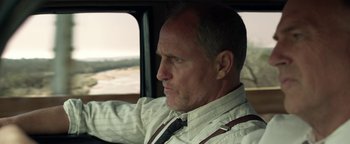 Movie still from “The Highwaymen” (2019), directed by John Lee Hancock – A person sitting in a car; Close Up shot, Low angle