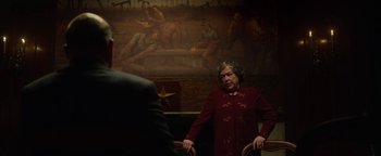 Movie still from “The Highwaymen” (2019), directed by John Lee Hancock – An older woman standing in front of a painting; Medium shot, Over the shoulder angle