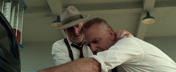 Movie still from “The Highwaymen” (2019), directed by John Lee Hancock – Two men in hats and ties are looking at each other; Close Up shot, Low angle