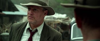 Movie still from “The Highwaymen” (2019), directed by John Lee Hancock – A person wearing a suit and a hat; Close Up shot, Low angle
