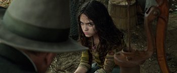Movie still from “The Highwaymen” (2019), directed by John Lee Hancock – A young girl sitting on the ground looking at the camera; Close Up shot, Over the shoulder angle