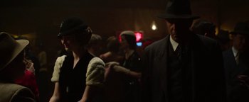 Movie still from “The Highwaymen” (2019), directed by John Lee Hancock – A group of people standing in a dark room; Medium shot, Over the shoulder angle