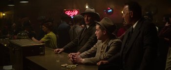 Movie still from “The Highwaymen” (2019), directed by John Lee Hancock – A couple of men sitting at a table in a room; Medium shot, Over the shoulder angle