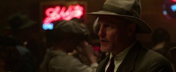 Movie still from “The Highwaymen” (2019), directed by John Lee Hancock – A man wearing a hat and a suit and tie; Close Up shot, Over the shoulder angle