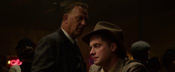 Movie still from “The Highwaymen” (2019), directed by John Lee Hancock – A man in a suit and a man in a hat; Close Up shot, Low angle
