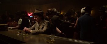 Movie still from “The Highwaymen” (2019), directed by John Lee Hancock – A group of people standing around a bar; Medium shot, Low angle