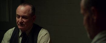 Movie still from “The Highwaymen” (2019), directed by John Lee Hancock – A man in a black vest and a white shirt; Close Up shot, Over the shoulder angle