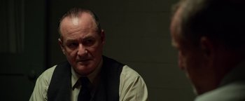 Movie still from “The Highwaymen” (2019), directed by John Lee Hancock – An older man in a vest and a tie; Close Up shot, Over the shoulder angle