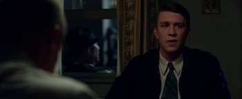 Movie still from “The Highwaymen” (2019), directed by John Lee Hancock – A man in a suit and tie sitting in front of another man in a suit and tie; Close Up shot, Over the shoulder angle