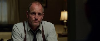 Movie still from “The Highwaymen” (2019), directed by John Lee Hancock – A person sitting in a room near a lamp; Close Up shot, Over the shoulder angle