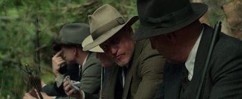 Movie still from “The Highwaymen” (2019), directed by John Lee Hancock – A group of men in suits and hats sitting next to each other; Close Up shot, Over the shoulder angle
