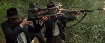 Movie still from “The Highwaymen” (2019), directed by John Lee Hancock – A group of men in suits and hats are holding guns; Medium shot, High angle