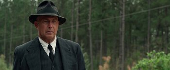 Movie still from “The Highwaymen” (2019), directed by John Lee Hancock – An older man wearing a suit and a hat; Close Up shot, Low angle