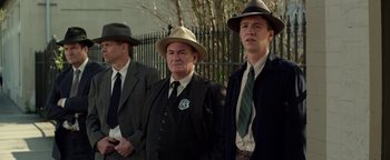 Movie still from “The Highwaymen” (2019), directed by John Lee Hancock – A group of men standing next to each other wearing hats; Medium shot, Low angle