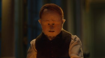 Movie still from “The House” (2022), directed by Paloma Baeza – A doll's face in the dark; Close Up shot, Low angle