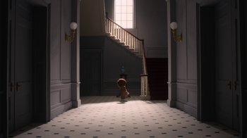 Movie still from “The House” (2022), directed by Paloma Baeza – A teddy bear is standing in the middle of the hall way; Extreme Wide shot, High angle