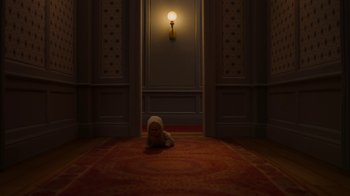 Movie still from “The House” (2022), directed by Paloma Baeza – A stuffed animal laying on the ground in a room; Wide shot, High angle