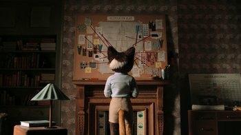 Movie still from “The House” (2022), directed by Paloma Baeza – A person standing in front of a fire place; Wide shot, High angle