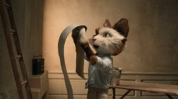 Movie still from “The House” (2022), directed by Paloma Baeza – A person dressed as a cat holding a piece of paper; Medium shot, Low angle