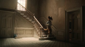 Movie still from “The House” (2022), directed by Paloma Baeza – A cat is walking down the stairs of a house; Wide shot, Low angle