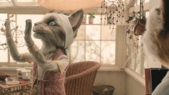 Movie still from “The House” (2022), directed by Paloma Baeza – A stuffed dog with a sweater on in a living room; Close Up shot, High angle