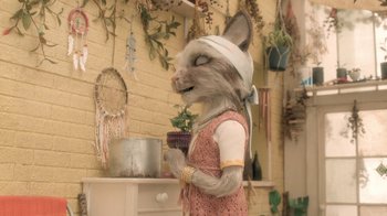 Movie still from “The House” (2022), directed by Paloma Baeza – A woman dressed as a cat in a room with plants; Medium shot, Over the shoulder angle