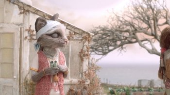 Movie still from “The House” (2022), directed by Paloma Baeza – A cat with a bandage around its neck and a cell phone in its mouth; Close Up shot, Over the shoulder angle