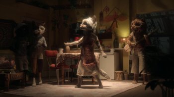 Movie still from “The House” (2022), directed by Paloma Baeza – A group of people standing in a room; Wide shot, High angle