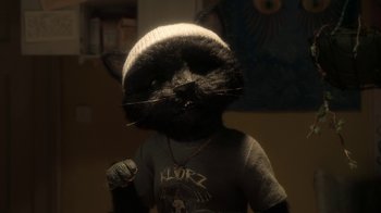 Movie still from “The House” (2022), directed by Paloma Baeza – A stuffed animal cat wearing a sweater and a hat; Close Up shot, High angle