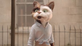 Movie still from “The House” (2022), directed by Paloma Baeza – A cat wearing a white shirt and brown pants; Medium shot, Low angle