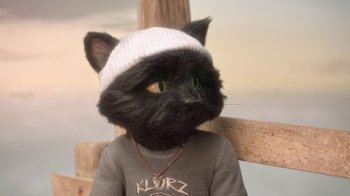 Movie still from “The House” (2022), directed by Paloma Baeza – A stuffed animal cat wearing a sweater and a hat; Close Up shot, High angle
