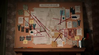 Movie still from “The House” (2022), directed by Paloma Baeza – A wall with a map of the restoration plan on it; Extreme Wide shot, Overhead angle
