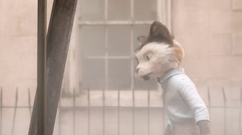 Movie still from “The House” (2022), directed by Paloma Baeza – A cat wearing a shirt and a tie; Medium shot, Low angle