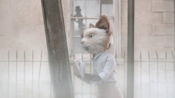 Movie still from “The House” (2022), directed by Paloma Baeza – A person wearing a cat mask standing next to a window; Medium shot, Over the shoulder angle