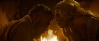 Movie still from “The Huntsman: Winter's War” (2016), directed by Cedric Nicolas-Troyan – A man and a woman face to face in front of a fire; Close Up shot, Over the shoulder angle