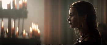Movie still from “The Huntsman: Winter's War” (2016), directed by Cedric Nicolas-Troyan – A woman with a crown looking at candles; Close Up shot, Over the shoulder angle